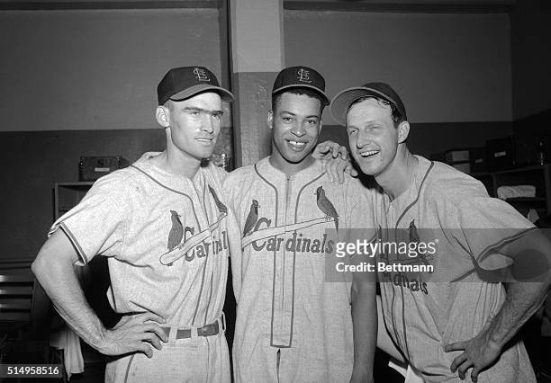 Out fielder Wally Moon , pitcher Brooks Lawrence and outfielder Stan Musial relax in their dressing room after leading the St. Louis Cardinals to a...