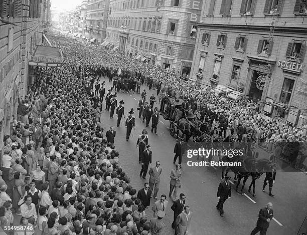 Crowd of nearly half a million Romans stands twenty deep as the glass-windowed Hearse pulled by six horses bears the coffin of former prime minister...