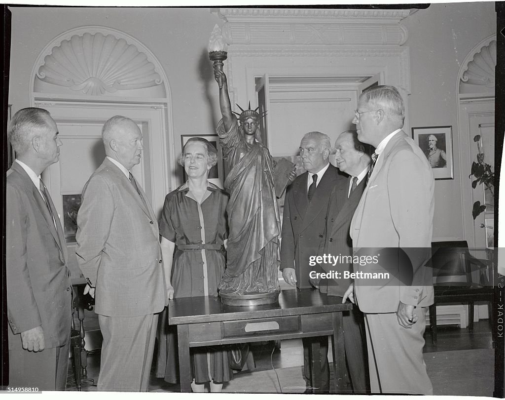 President Eisenhower Looking at a Model Statue of Liberty