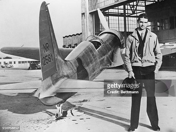 Howard Hughes' first plane, the H-1, a featherweight midget, was the ancestor of his newly-built "flying boat," compared to Hughes' latest Goliath -...