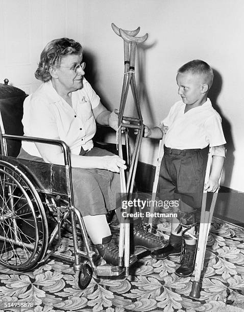 The old look and the new look in crutches are compared by a victim of the first polio epidemic recorded in the United States in 1894 and a victim of...