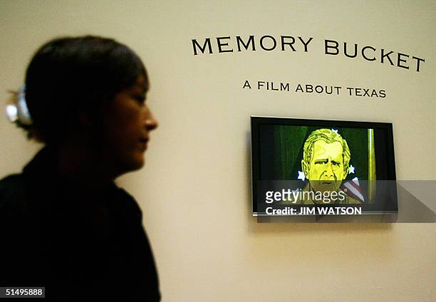 Vidoe of US President George W. Bush pops up on screen as a woman sits watching shortlisted artist Jeremy Deller's documentary 'Memory Bucket', which...