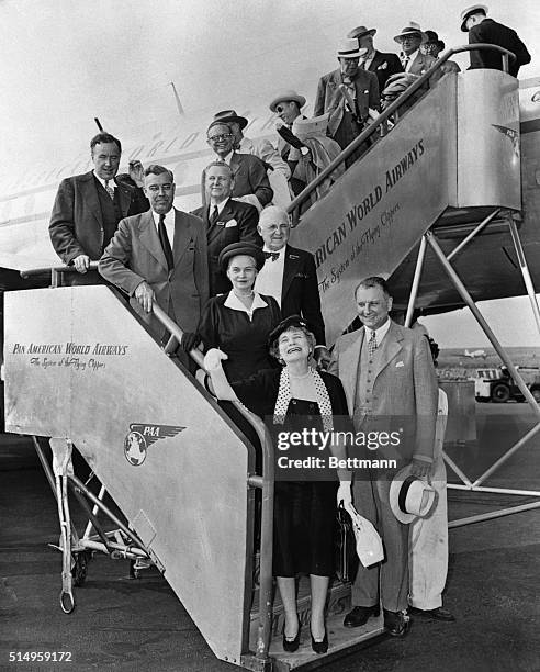 Globe-circling publishers and editors as they disembarked at LaGuardia Field today after completing the first commercial flight around the world....