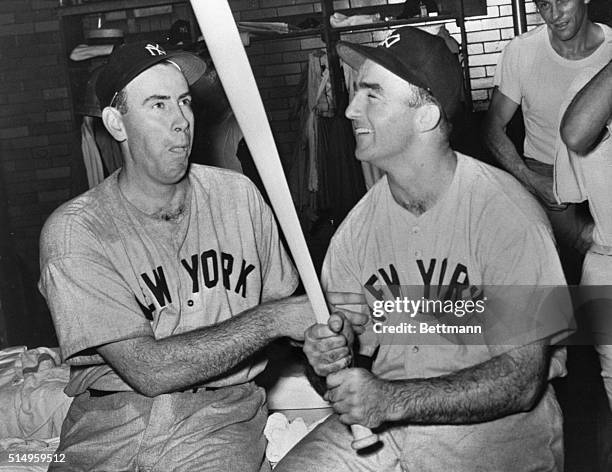 Bill Bevens, Yankee pitcher, sits with tongue in cheek as he admires the bat in the hands of Bill Johnson which kept the Yank's unbeaten string going...