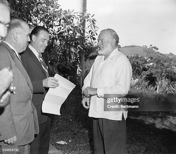 Ernest Hemingway, 56 year old novelist from Oak Park, Illinois, receives reporters at "La Vigia," his home near Havana, where he lived for years,...