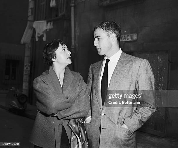 Movie actor Marlon Brando chats with his happy fiancee, Josiane Mariani Berenger, after announcing their engagement. They plan to be wed next June.