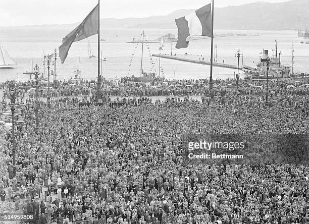 Huge Italian tricolor flies before the Trieste flag over the Piazza Unita as crowds greet the Italian-Yugoslav pact with cheers and singing. The...