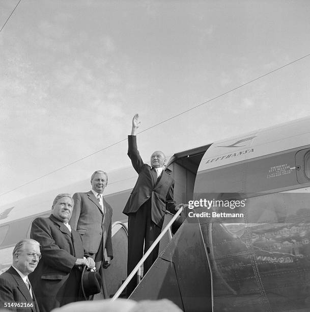 Adenauer Takes Off for Moscow. Bonn, West Germany: West German chancellor Konrad Adenauer waves to the crowd as he climbs into the four engined plane...