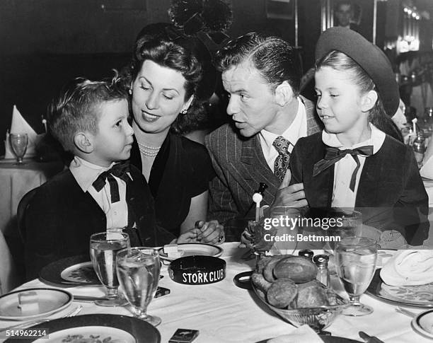 Frank Sinatra Entertains Family at Stork Club, New York. New York, New York: Sinatra takes time out to entertain his wife and youngsters, Nancy and...