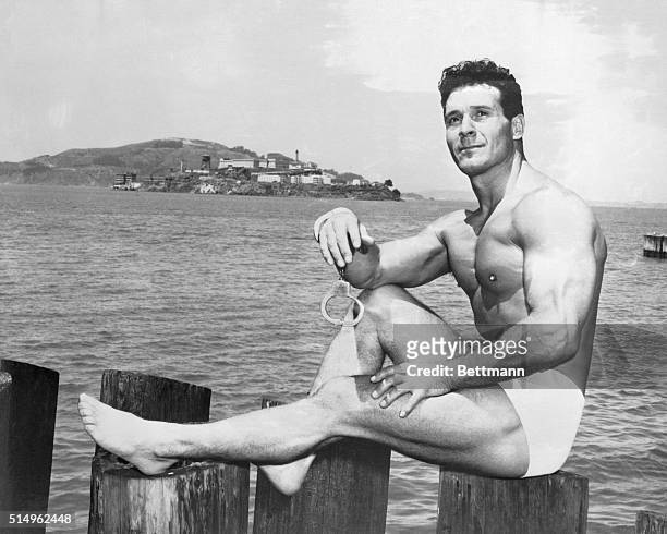 Body builder Jack LaLanne, a former Mr. America, poses against a background of Alcatraz Island. Starting at a point near the famed island prison,...