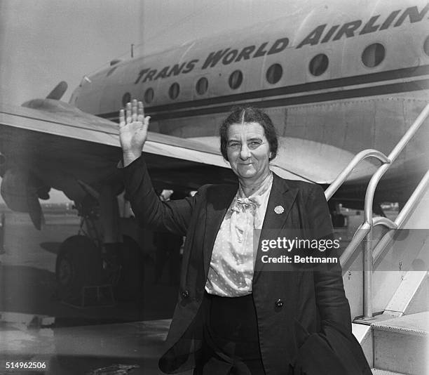 The Prime Minister of Israel, Golda Meir, is seen waving in front of a plane after arriving in New York City.