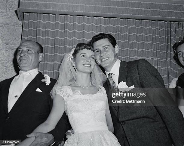 Mr. And Mrs. At Last. Grossinger, N.Y.: Film actress Debbie Reynolds and crooner Eddie Fisher cuddle for cameramen after their marriage at...