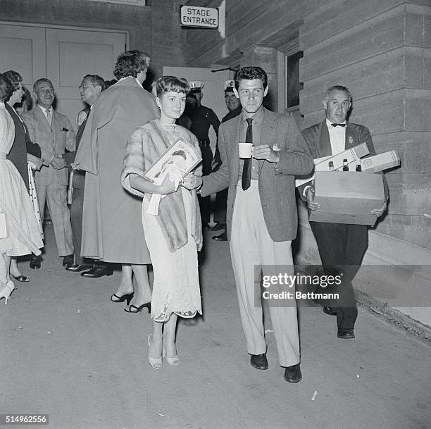 Between the Acts. Long Beach, Calif.: Actress Debbie Reynolds and singer Eddie Fisher stretch their legs in the lobby of the Long Beach Municipal...