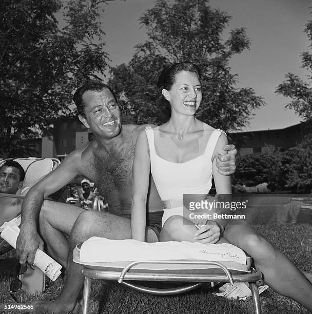 Double Billing--Between a busy schedule in Las Vegas, Nevada, Tony Martin and his wife Cyd Charisse, absorb some sun at the Flamingo where the singer...