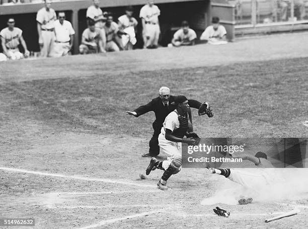 Detroit's Harvey Kuenn is safe at home on Bill Tuttle's single to left field in the sixth inning of the August 6th game with the Yankees. The play...