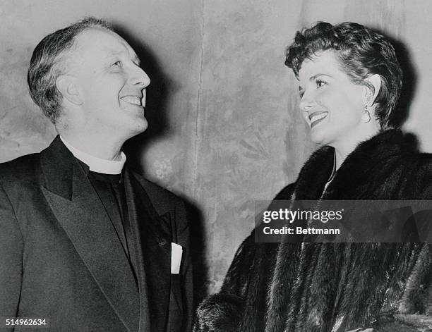 Film star Jane Russell enjotys an animated chat with the Rev. A.W. Goodwin Hudson Vicar of St. Mary Magdalen, Highgate, as both attend the London...