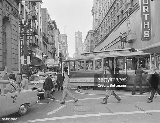 Cable car, one of San Francisco's most colorful "trademarks," is spun on a turntable at Market Street for its climb back up Powell Street, , and over...