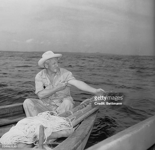 Enacting their first scenes in the film of Ernest Hemingway's The Old Man and the Sea, veteran movie actor Spencer Tracy works on fishing lines at...