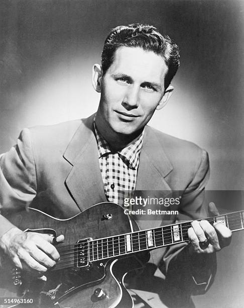 Country singer Chet Atkins playing the guitar.
