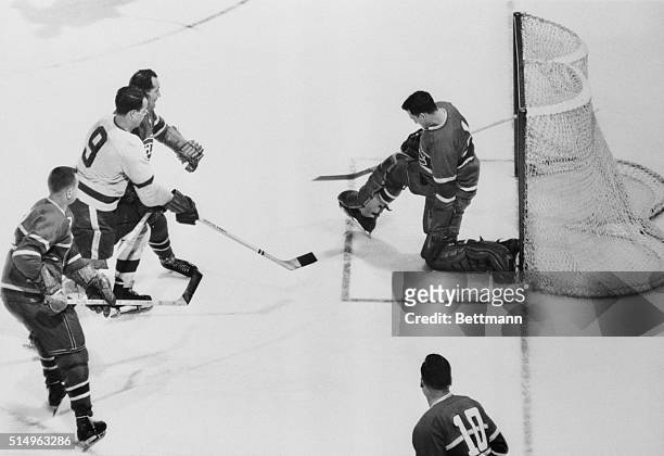Montreal Goalie Jacques Plante kicks out shot by Detroit's Godie Howe as Canadian's beat Red Wings 3-1, capture the Stanley Cup and World Pro Hockey...