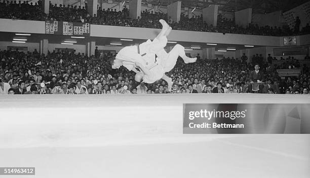 Vincent Tamura, of the U.S., and Otto Schlatter of Switzerland, rotate in the air like fighting birds, during their match in the first World Judo...