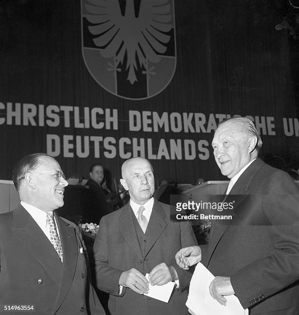 West German Chancellor Konrad Adenauer chats with Jakob Kaiser , Minister for German Affairs, and Eugene Gerstenmaier , president of the Bundestag,...