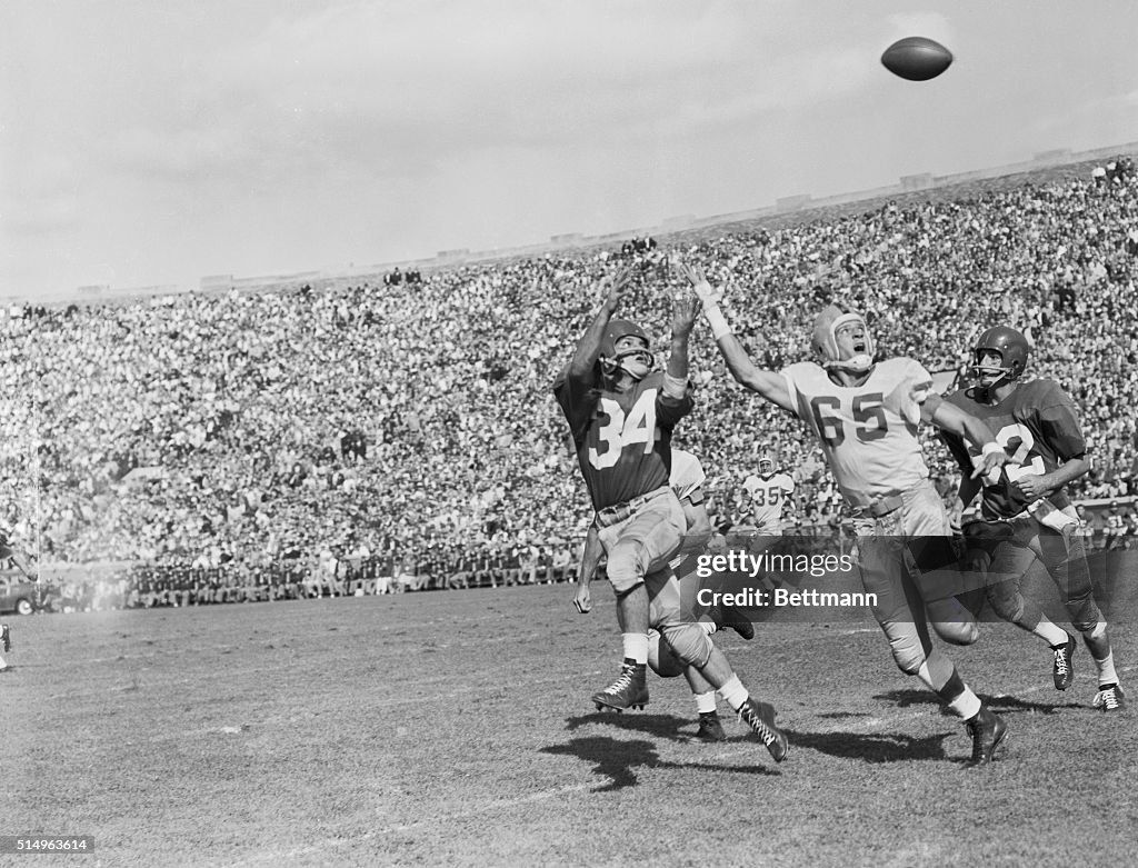 Football Players Reaching for the Ball