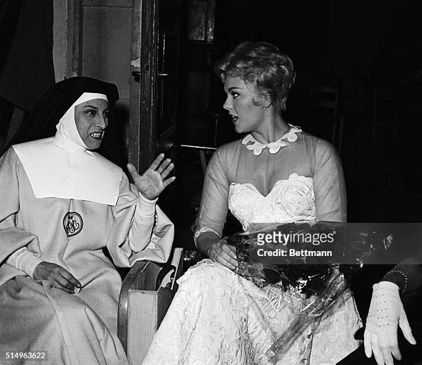 Lovely Hollywood actress Kim Novak gets some acting pointers from a pro, as she talks with Italian actress Anna Magnani on the set of When Angels...