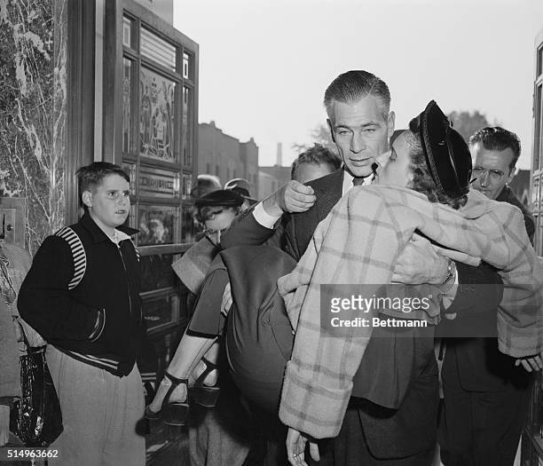 Chicago, Illinois: Collapsed in grief, Mrs. Anton Schuessler is carried into church by a friend for the double funeral of her sons, John and Anton...