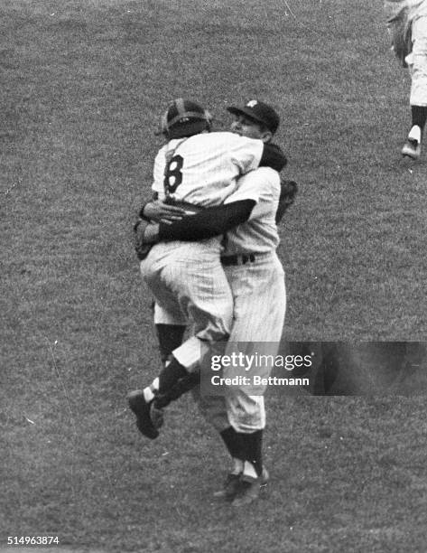 Yankee catcher Yogi Berra jumps up and down as he hugs teammate Don Larsen, following Larsen's feat of pitching the first perfect game in World...