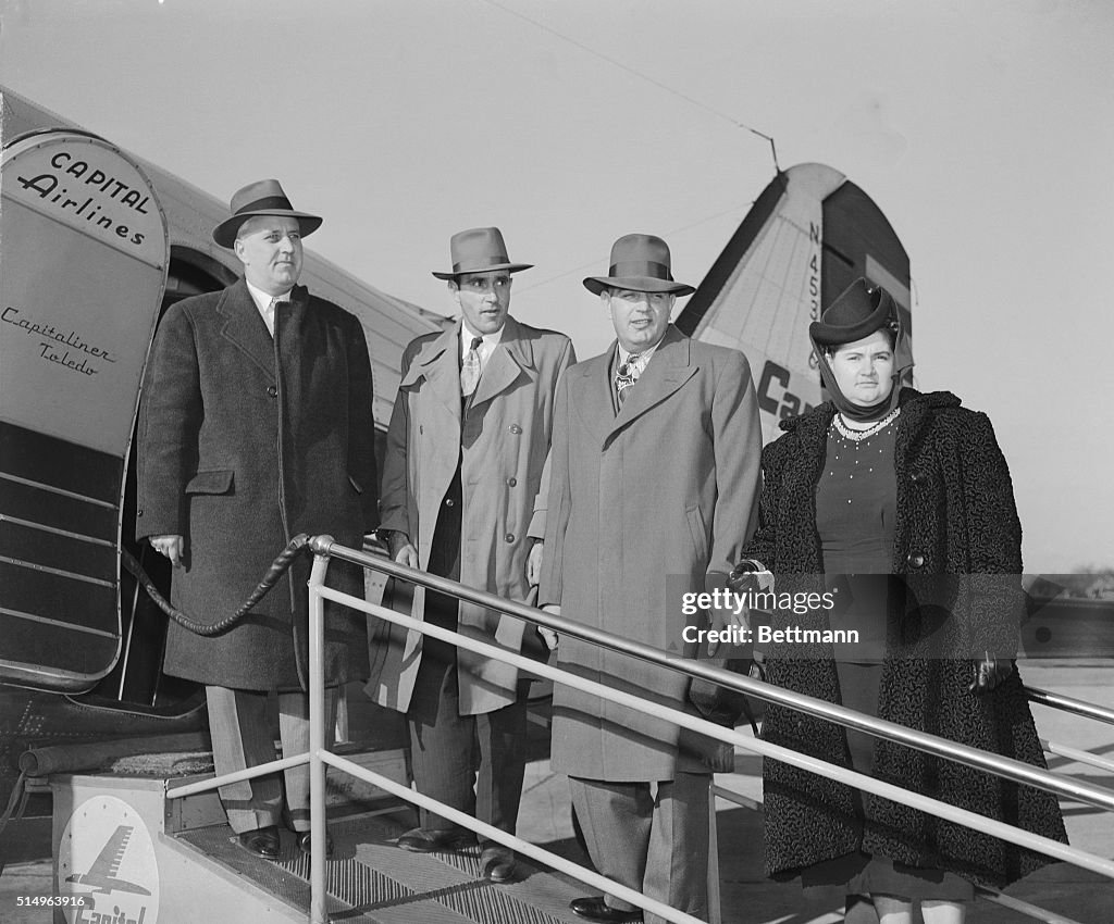 Murder Suspects and New York Officials Boarding Airplane