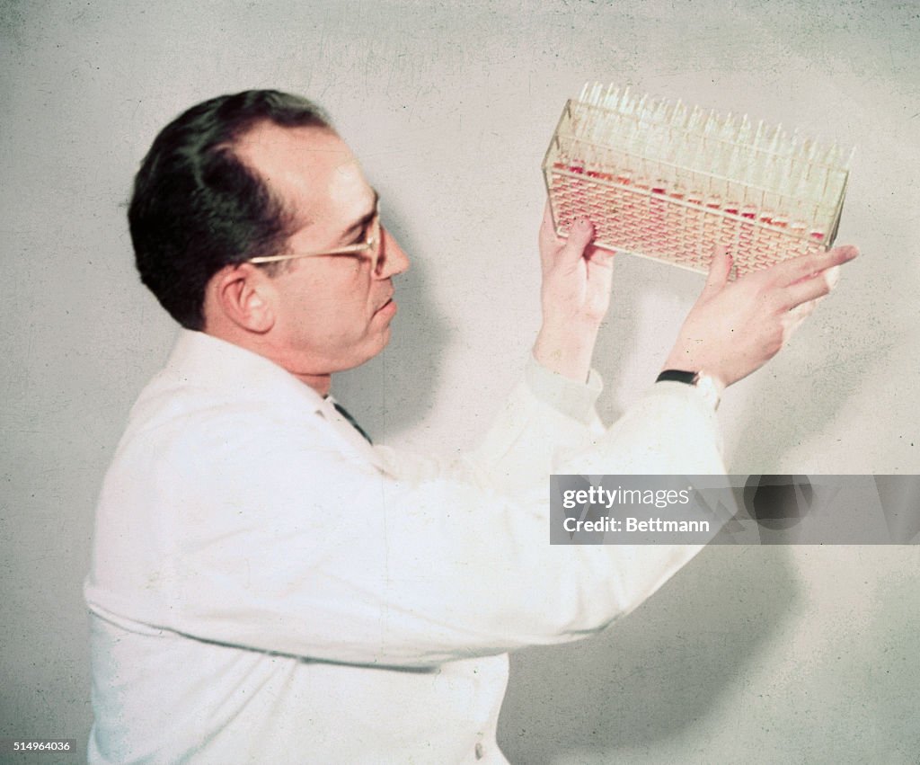 Scientist Jonas Salk Examining Vials
