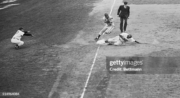 Jackie Robinson, speedy Dodger skids safely into third base, safe on a steal in the seventh inning against the Philadelphia Phillies. Jones, covering...