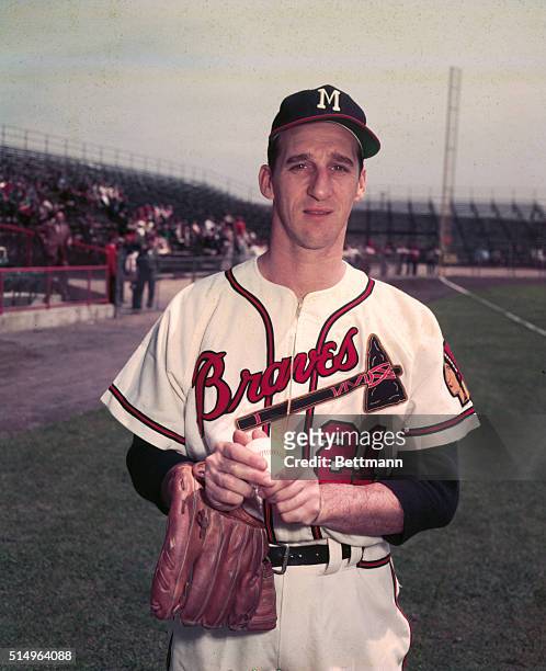 Photo of Milwaukee Braves pitching ace Warren Spahn holding a baseball.