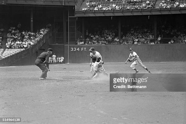 Second baseman Jackie Robinson of the Brooklyn Dodgers is shown stealing second base in the fourth inning of the game with the Philadelphia Phillies...