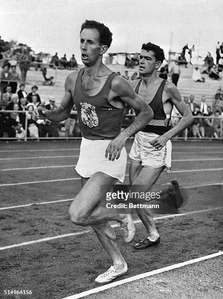 Melbourne, Australia: Just a pace behind world mile champion John Landy, 19-year-old Ron Clarke, shown here when Landy broke the four-minute mile at...