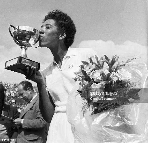 Althea Gibson kisses the cup she was rewarded with after having won the French International Tennis Championships in Paris.