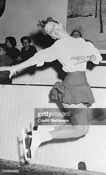 Displaying her championship form in a practice leap here February 28th, 17-year-old Carol Heiss, of Ozone Park, N.Y., gets ready for the final events...