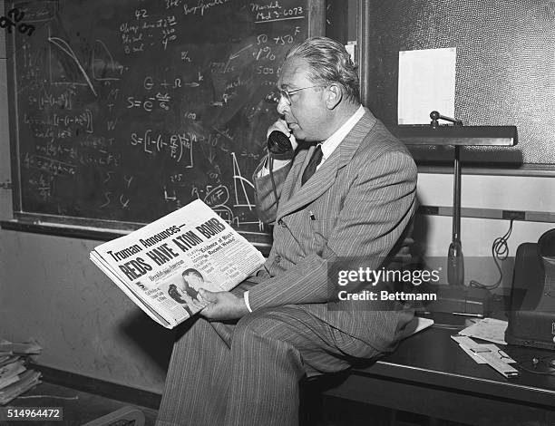 Dr. Leo Szilard professor-University of Chicago looking at headline in Herald American "Reds Have Atom Bomb".
