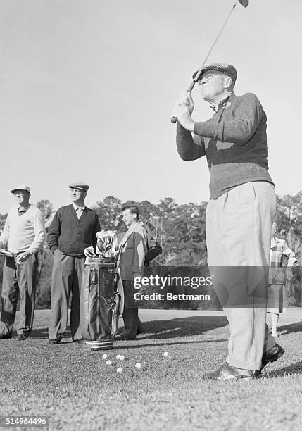 Thomasville, GA.: Fore! President Eisenhower adds a little body English as he tees off during a morning golf outing at Glen Arven Country Club here...