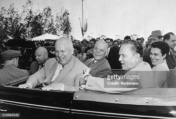 All smiles in Moscow. Moscow, Russia: Laughing and smiling, visiting Yugoslavian president Tito, his wife, and three Russian leaders ride in an open...