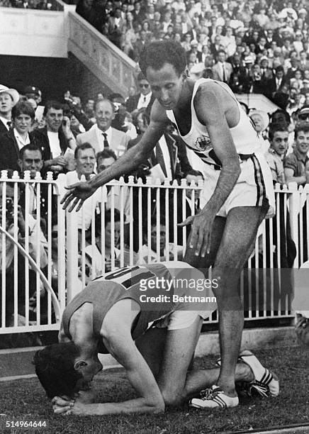 Australian John Landy, who came third, bends to congratulate Ireland's Ron Delaney in this photo, after the latter had won the Olympic 1,500 meters...