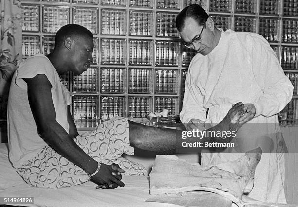 Dr. Bruce Brewer washes the ankle of Milwaukee Braves outfielder Hank Aaron after removing the slugger's cast. Aaron broke his ankle sliding into...