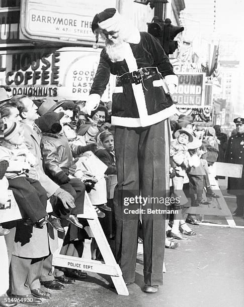 New York City: Man Of The Moment. It was quite a treat for these youngsters when a Santa Claus on stilts stopped to shake hands with them and find...