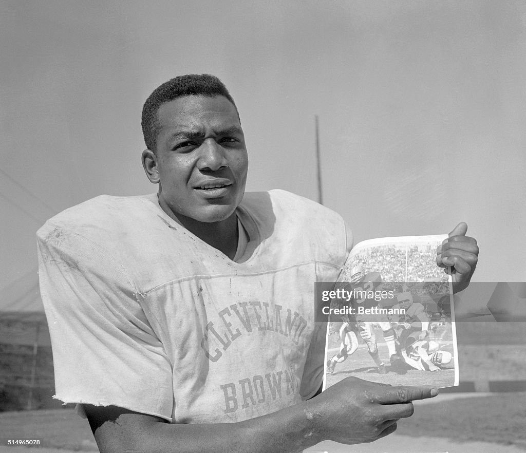 Jim Brown Holding up Photo of Himself