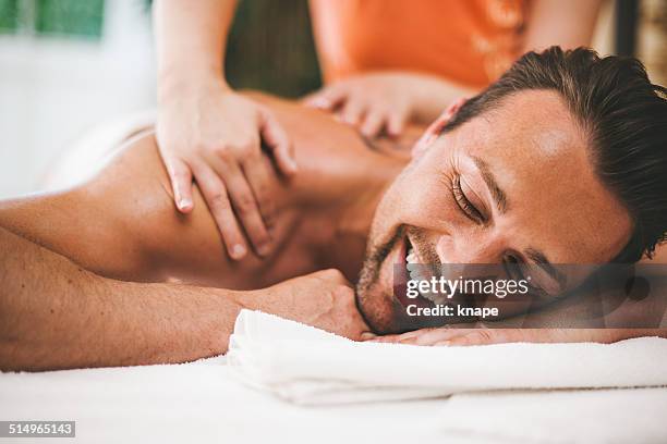 man getting a massage at the healthspa - massage stock pictures, royalty-free photos & images