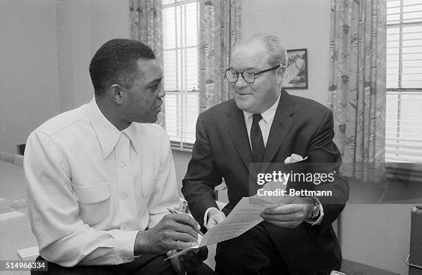 San Francisco Giants centerfielder Willie Mays signs his 1958 contract here Jan 6th. Club president Horace Stoneham holds contract for him. The first...