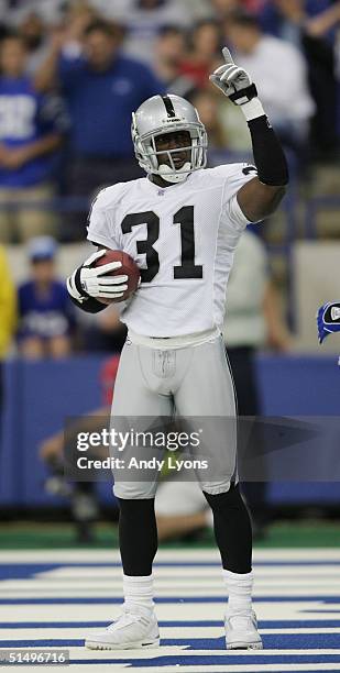 Cornerback Phillip Buchanon of the Oakland Raiders celebrates int he endzone during the game against the Indianapolis Colts at the RCA Dome on...