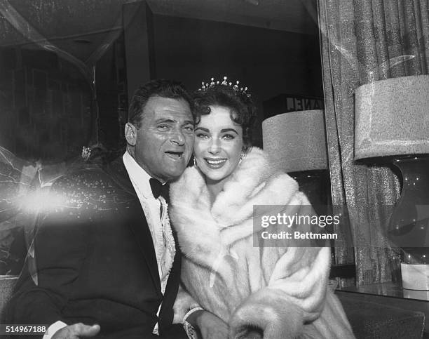 Hollywood, CA- Mike Todd and his wife, Elizabeth Taylor, playfully mug for photographers as they arrive at a party after the Academy Award...