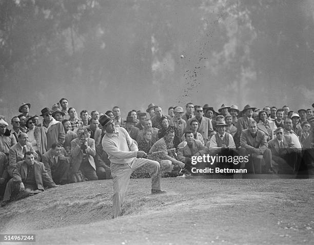 Photo shows Sammy Snead as he blasts out of a sand trap on the fourth hole in a playoff today with mighty Ben Hogan for title in Los Angeles Open...